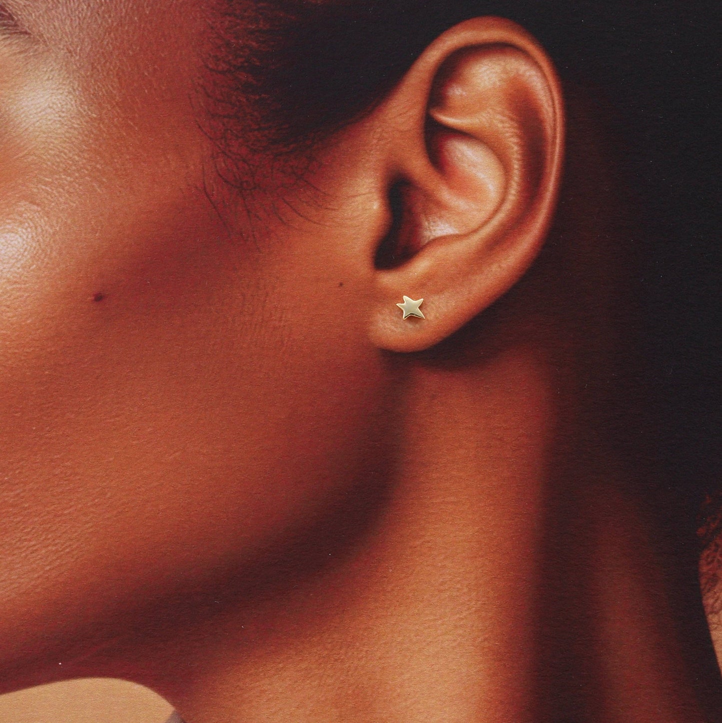 Gold Star Earrings with penguin graphic