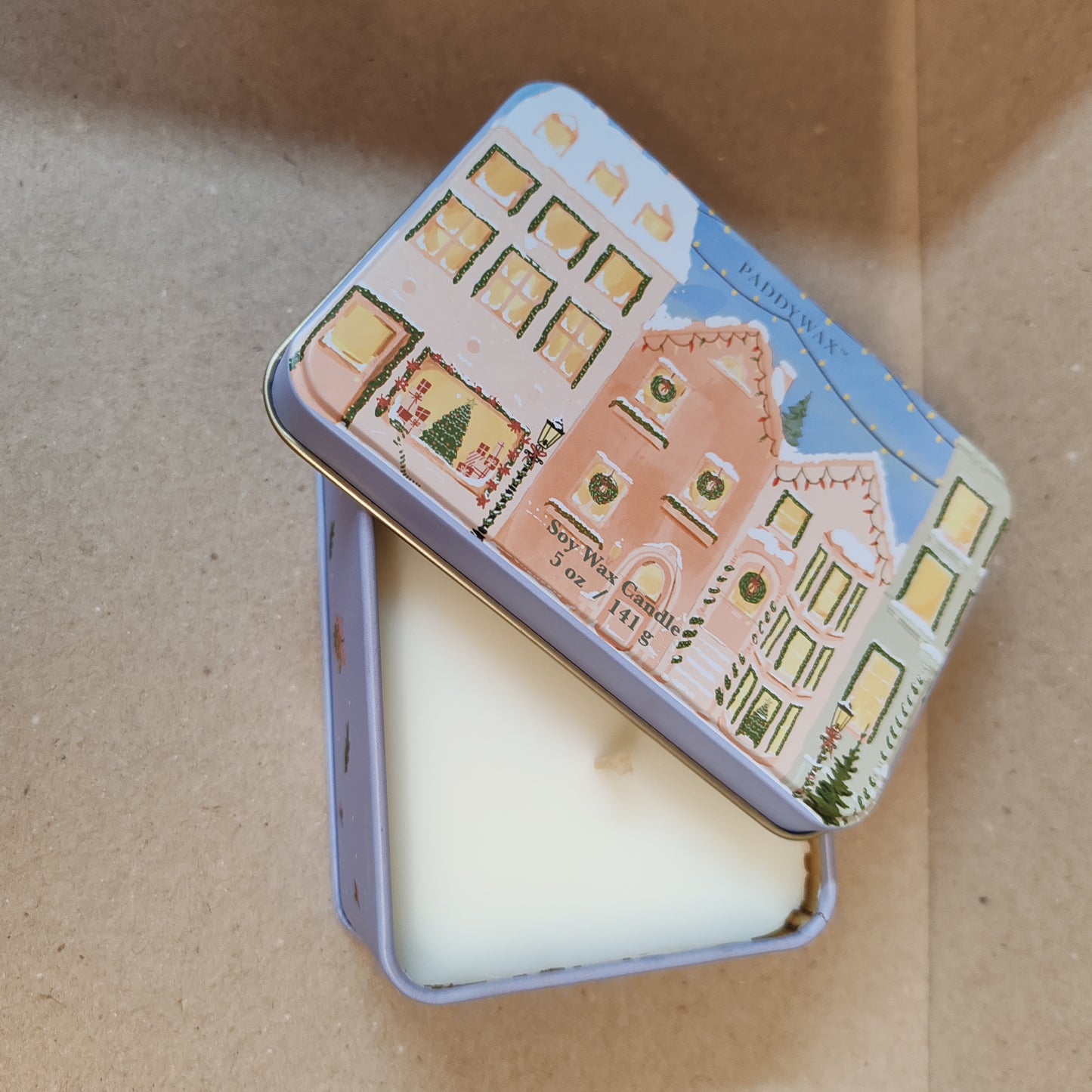 5oz printed tin scene of Christmas village. Scent of Gingerbread