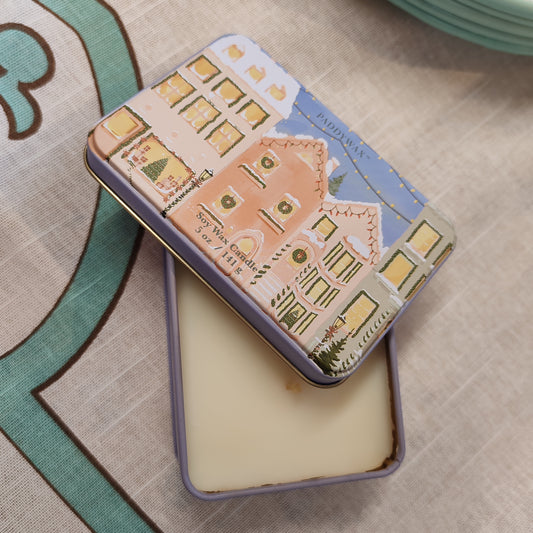 5oz printed tin scene of Christmas village. Scent of Gingerbread