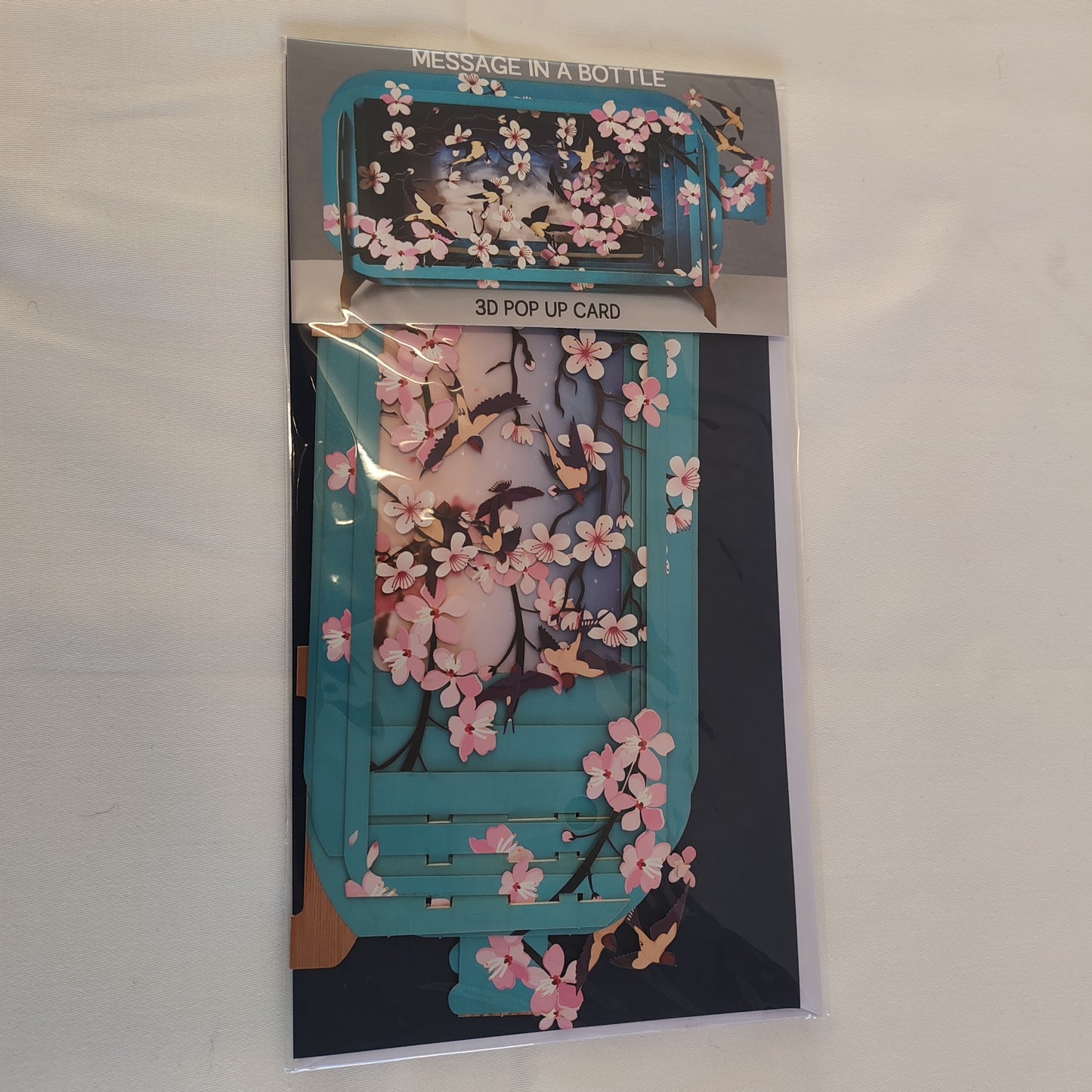 Message in a bottle 3d pop up greeting card. Cherry blossom theme.