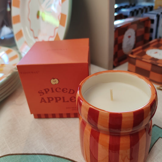 6.5oz scented candle in red and coral stripe ceramic pot. Tangerine and clove
