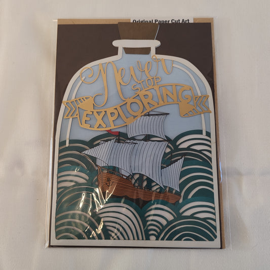 Never stop exploring pierced out greeting card. Ship in a bottle design