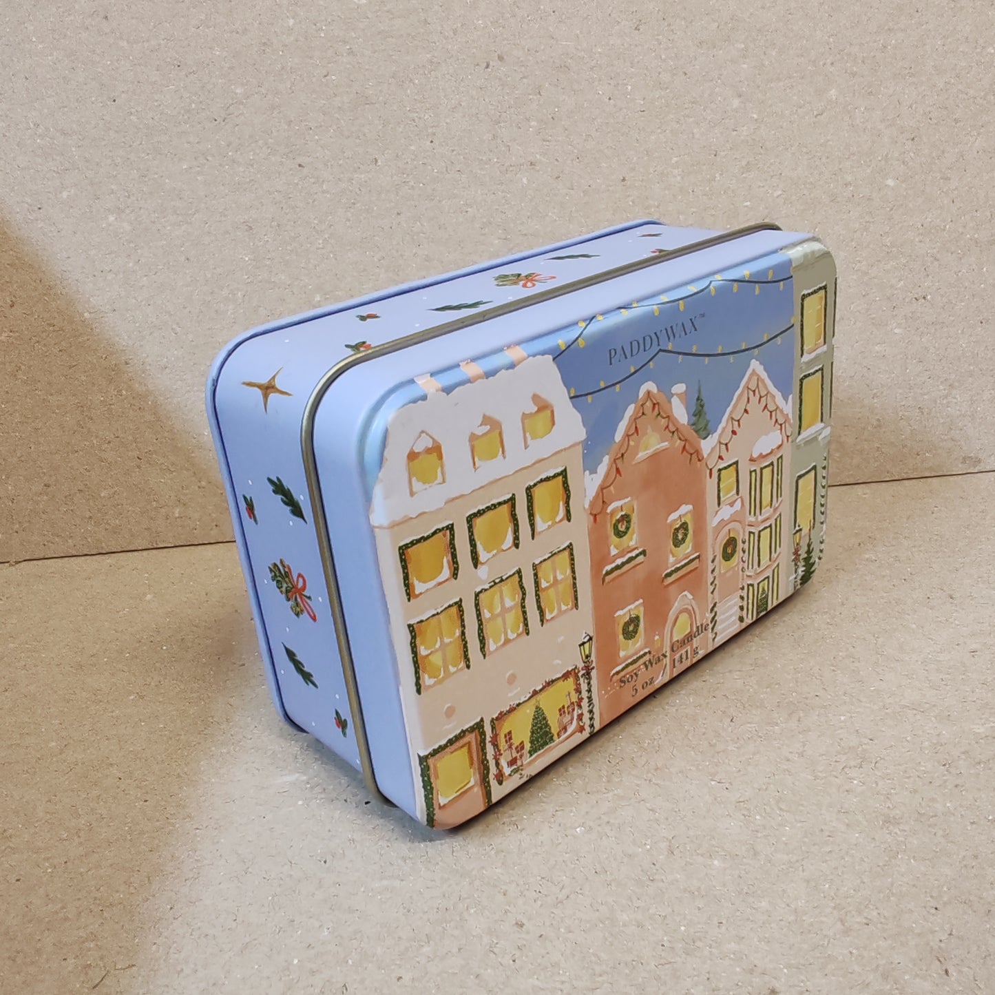 5oz printed tin scene of Christmas village. Scent of Gingerbread