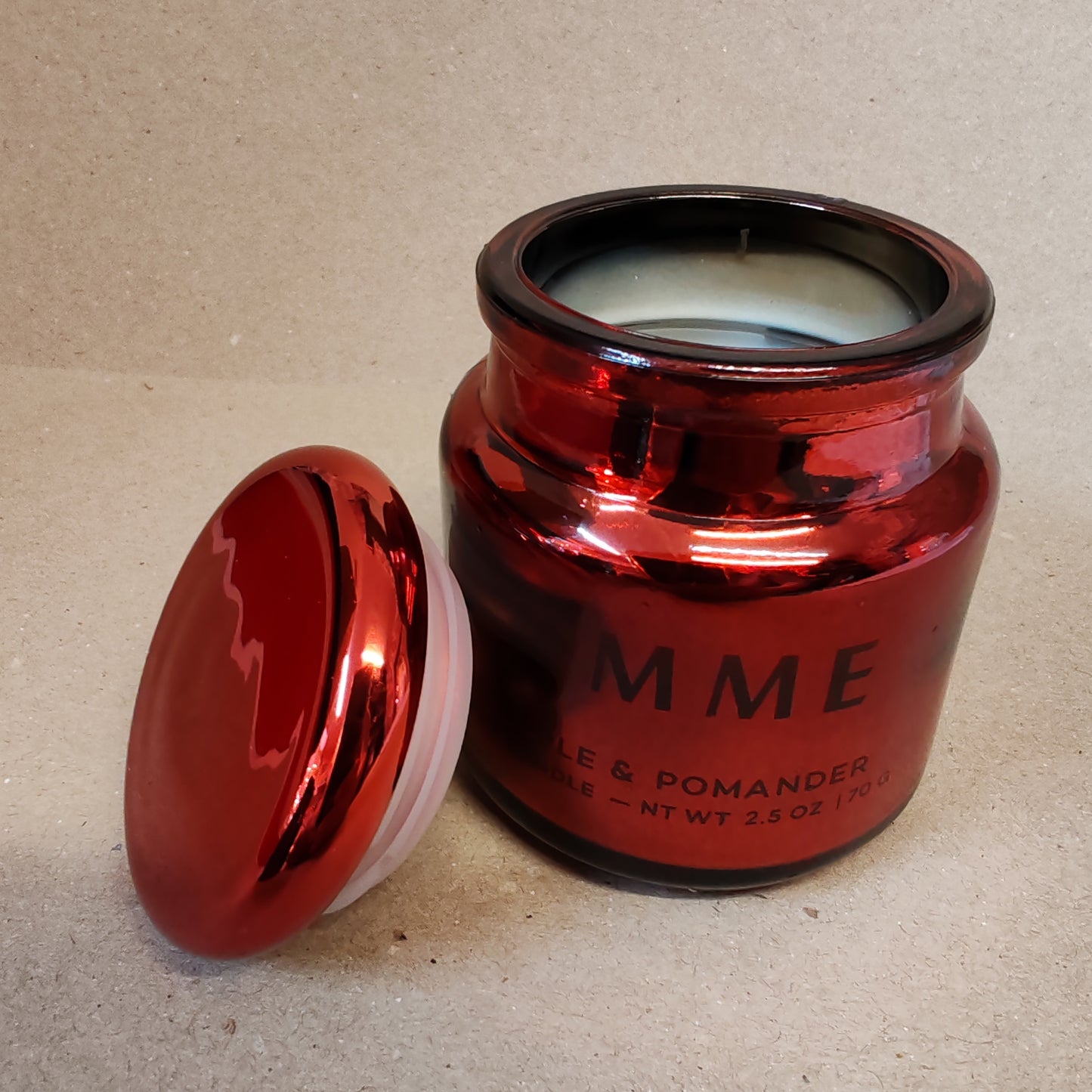 Scented candle in a red chrome glass jar. Scent of red apple and pomander.