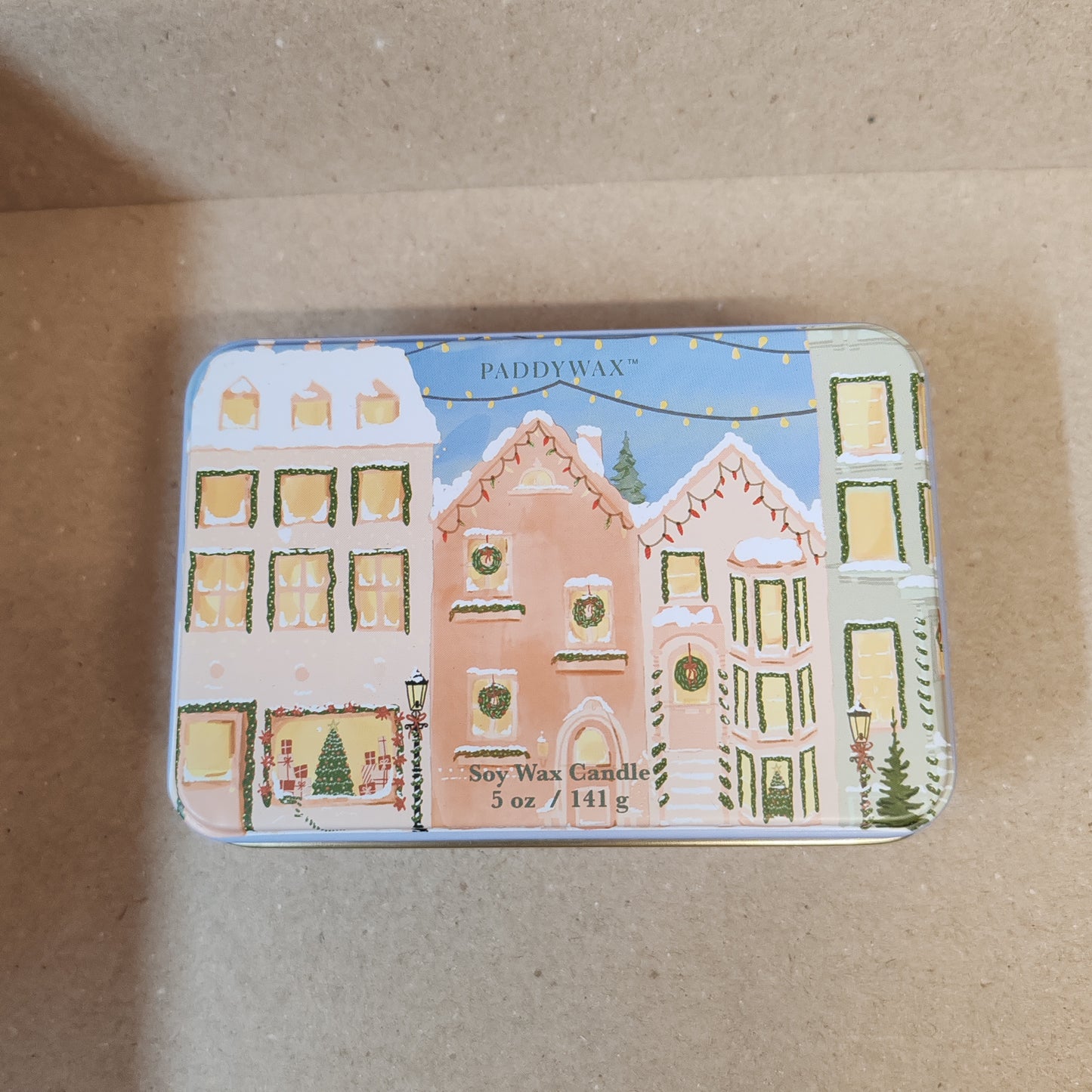 5oz printed tin scene of Christmas village. Scent of Gingerbread