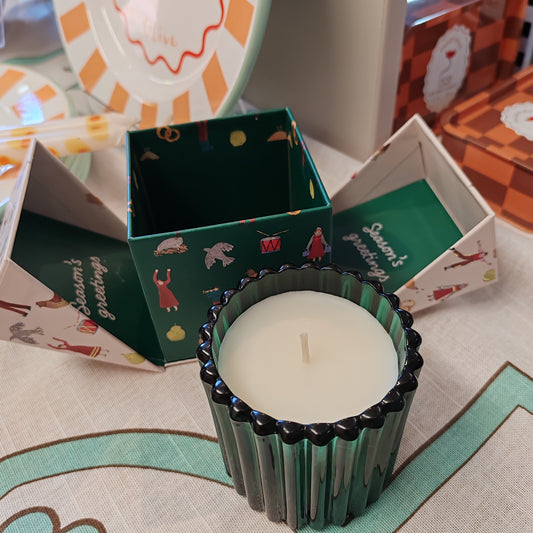 Festive fir and balsalm scented candle in a green glass votive. Exquisite packaging