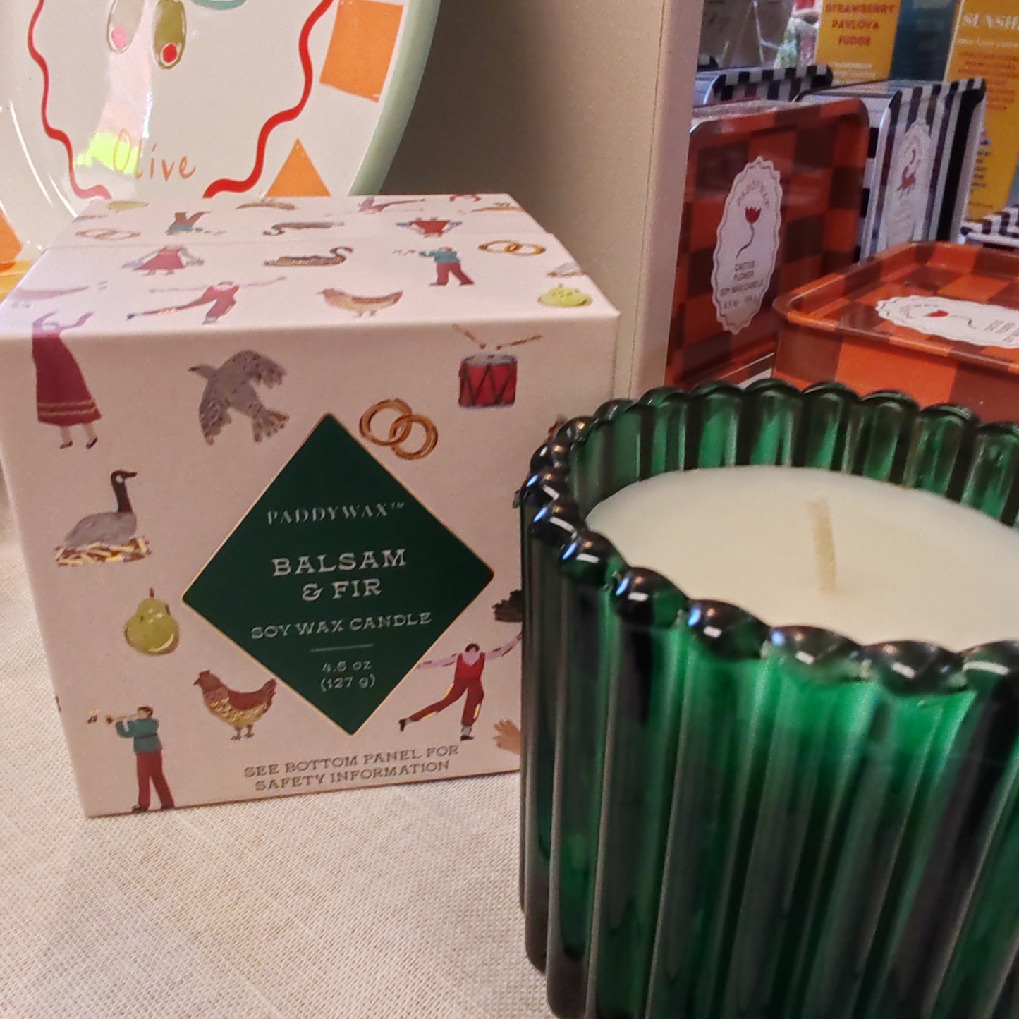 Festive fir and balsalm scented candle in a green glass votive. Exquisite packaging