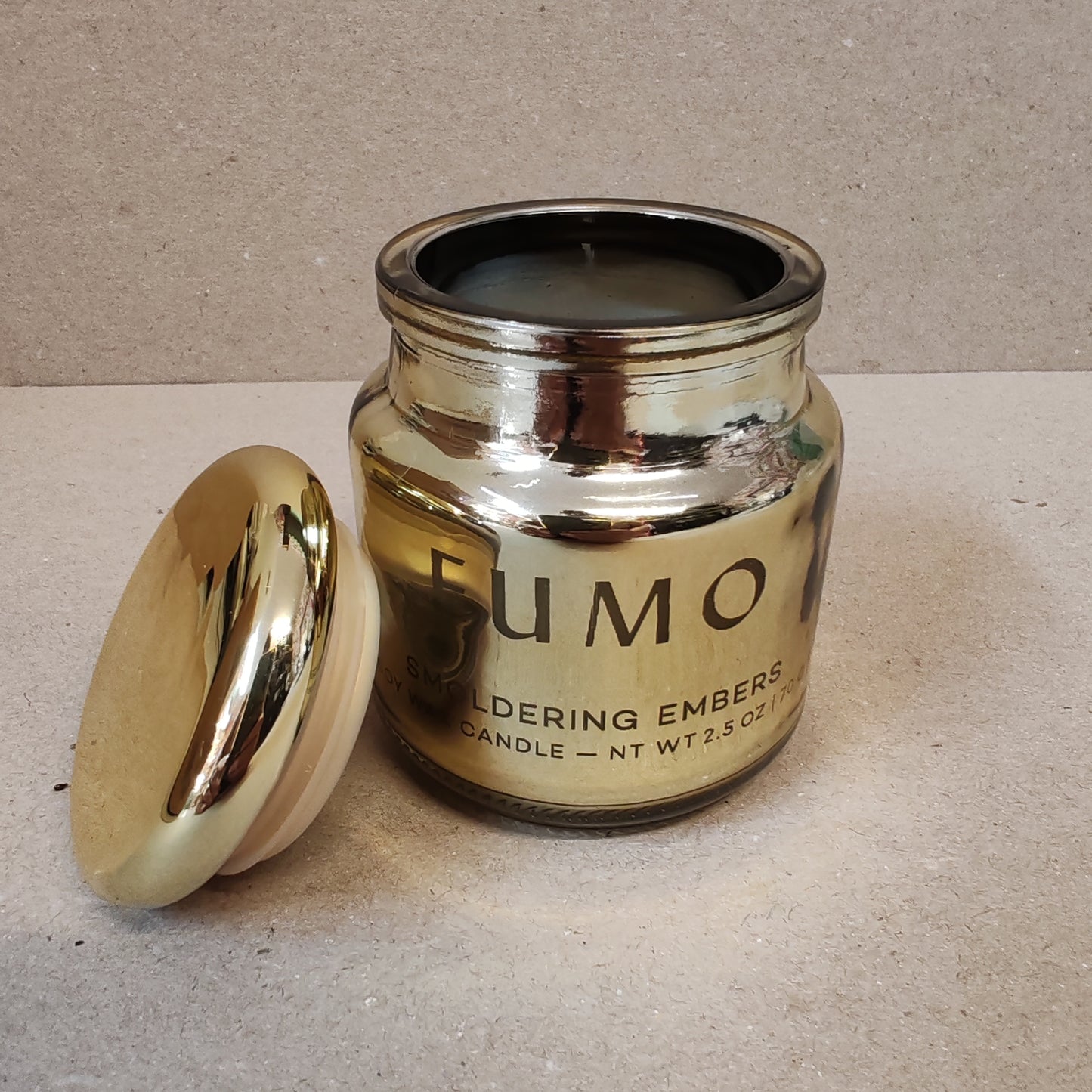 Chrome 2.5oz scented candle in gold metallic glass container . Scent of Smoldering embers.
