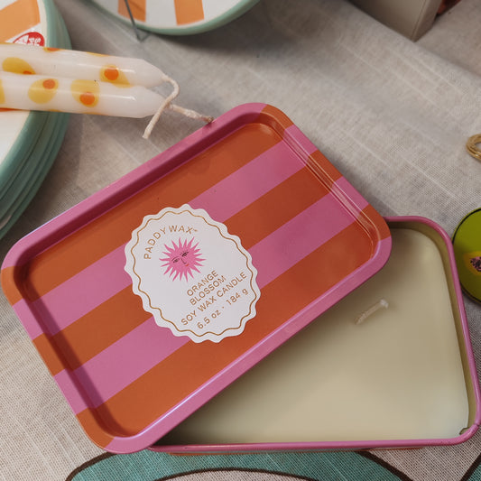 Scented candle in a stripey decorative tin. Scent of orange blossom