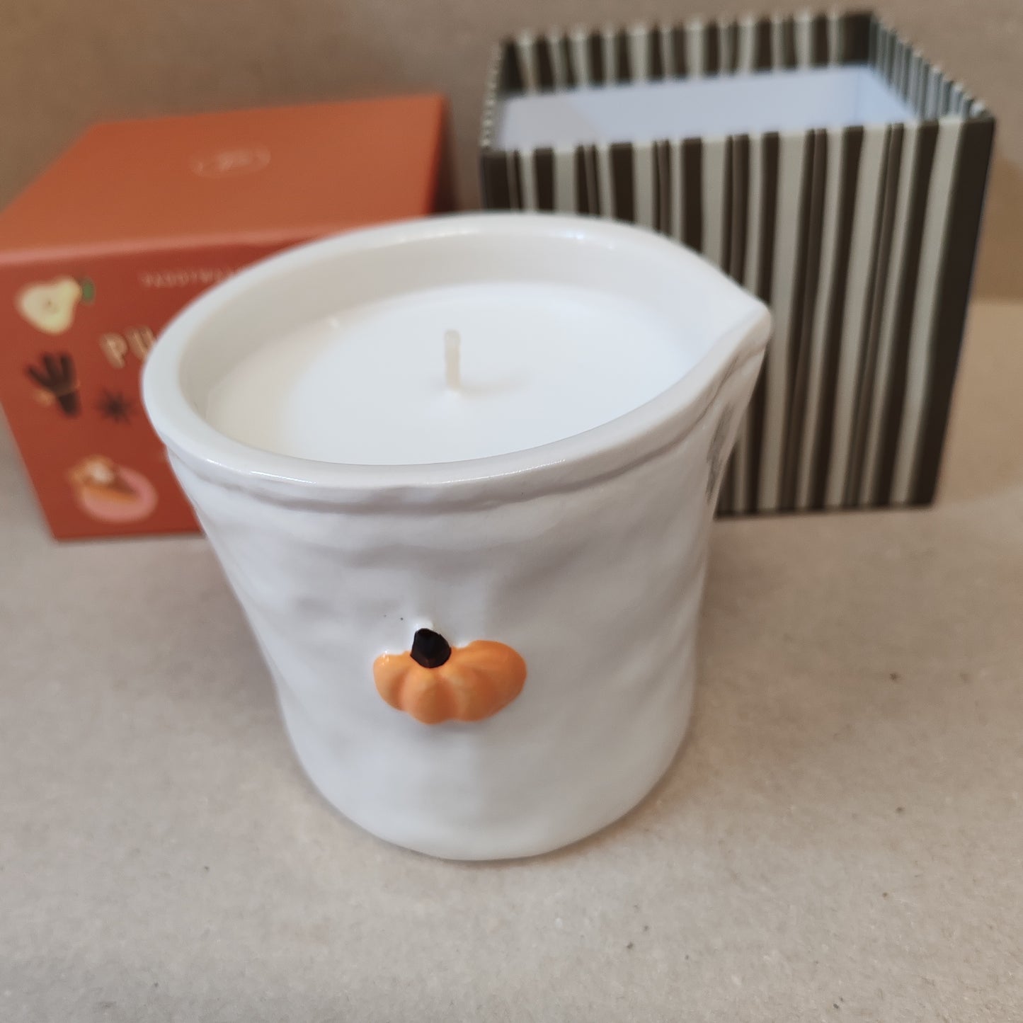 Bistro 8oz pumpkin scented candle in a ceramic pot.