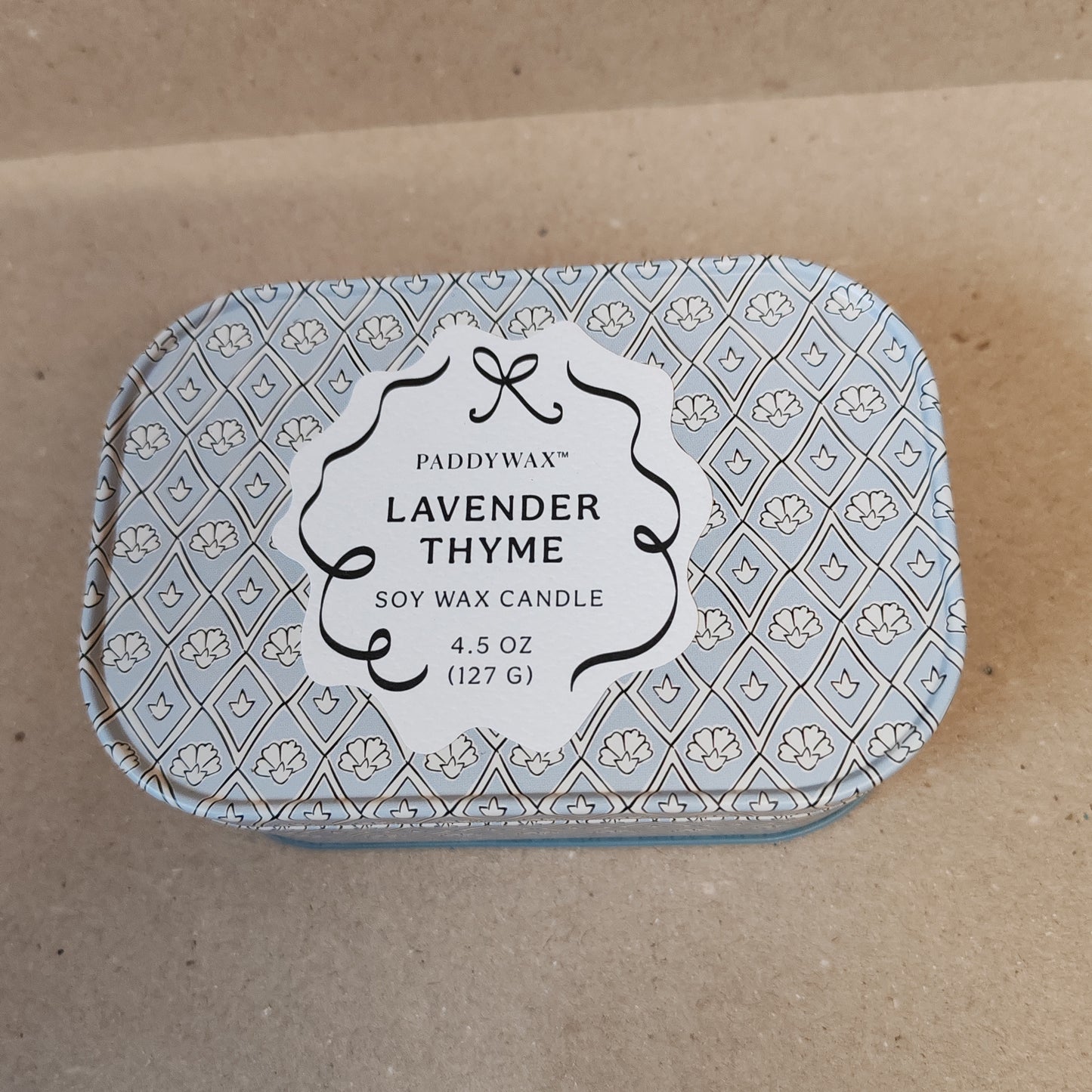 Scented 4.5oz scented candle in printed blue and white tin. Scent of lavender and thyme.