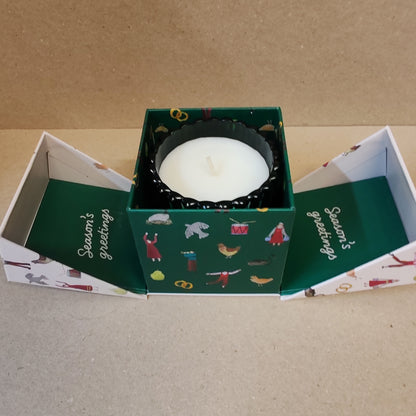 Festive fir and balsalm scented candle in a green glass votive. Exquisite packaging