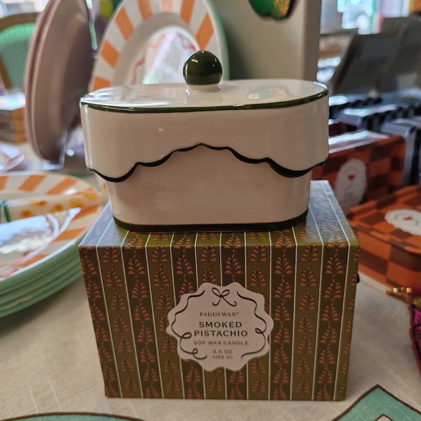 Cherie 5.5oz scented candle in porcelain lides pot with drawer packaging. Scent of Smoked Pistachio.