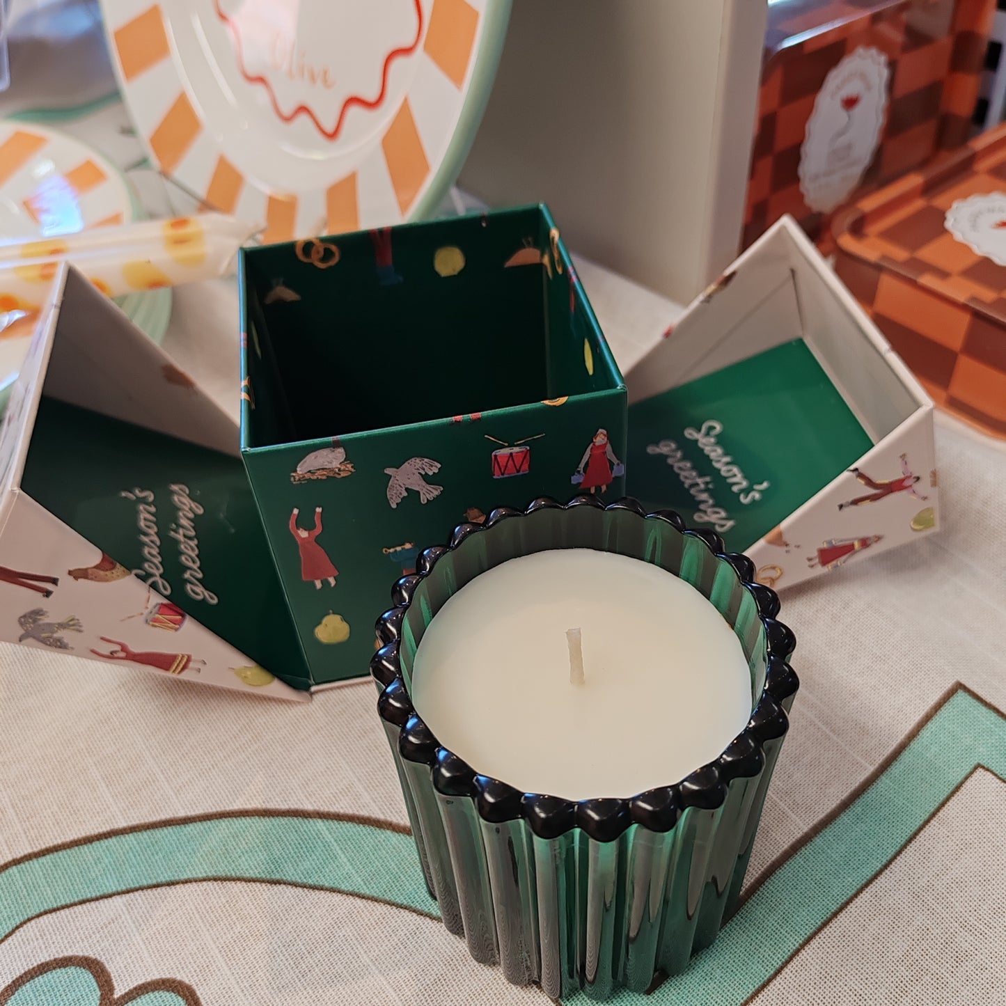 Festive fir and balsalm scented candle in a green glass votive. Exquisite packaging