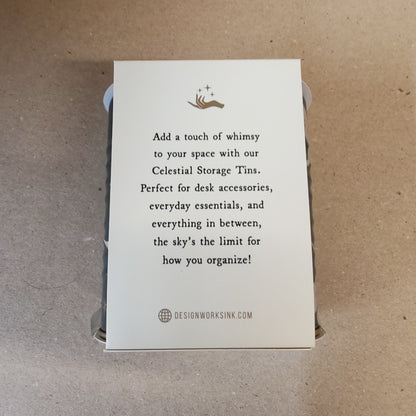 Celestial storage tin decorated with moon faces.